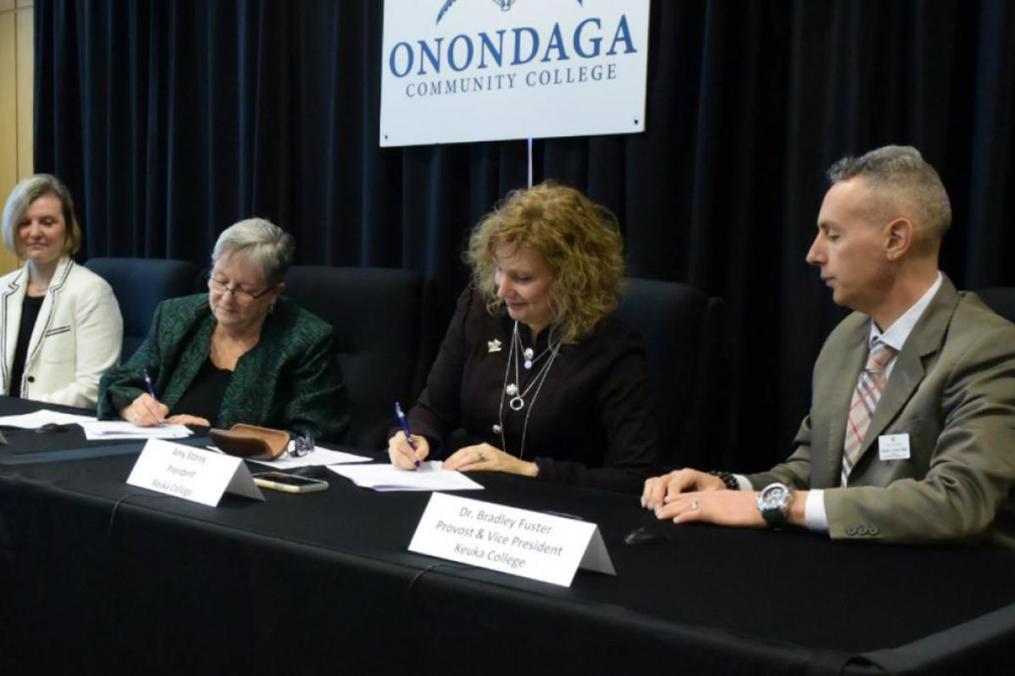 Officials from Keuka College and Onondaga Community College sign a partnership agreement for the BSW degree.