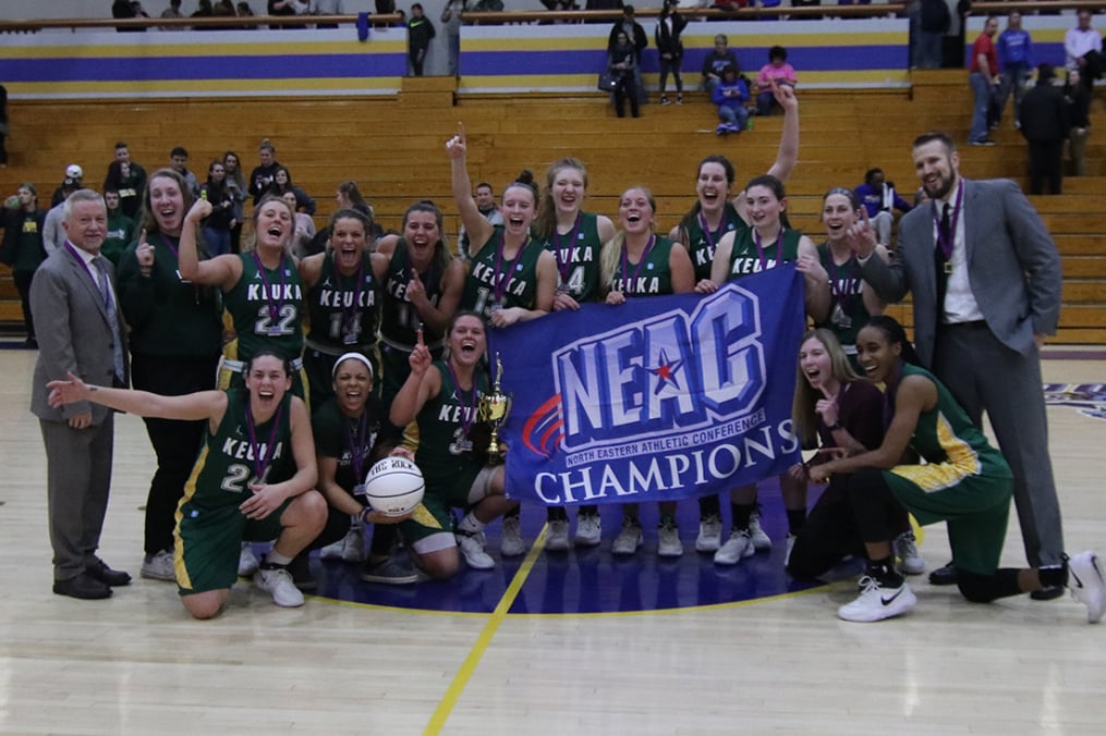 Women's Basketball team with NEAC banner