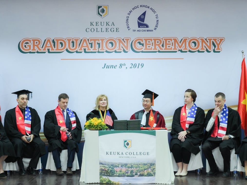 Keuka College President Amy Storey is joined at center stage by University of Science Dr. Tran Minh Triet during graduation ceremonies for the Keuka College Vietnam Program at the University of Science in Ho Chi Minh City. 