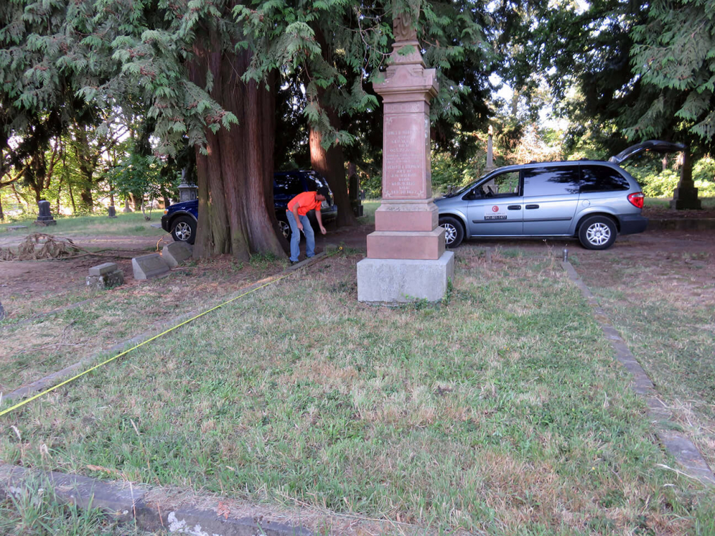 Reid Davis of Concrete GPR taking detailed measurements of the entire burial plot.  The roots of the large cedar to the left of the picture had grown roots all through the graves.