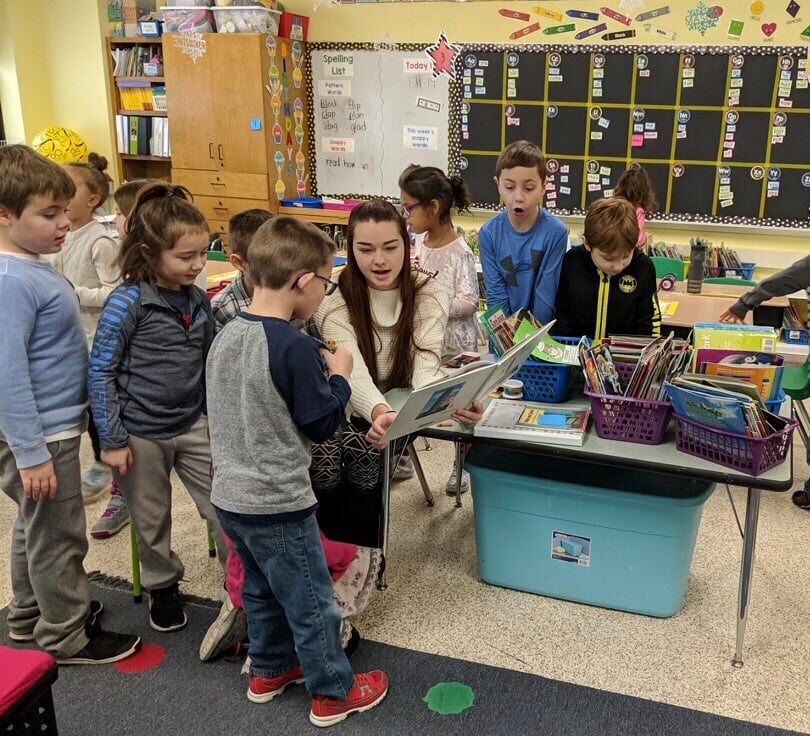 Student works with children in school during field period for keuka college
